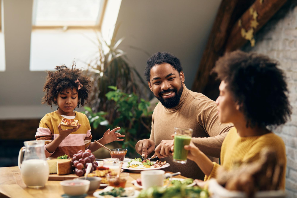 Black Family Talking While Having Breakfast At Home