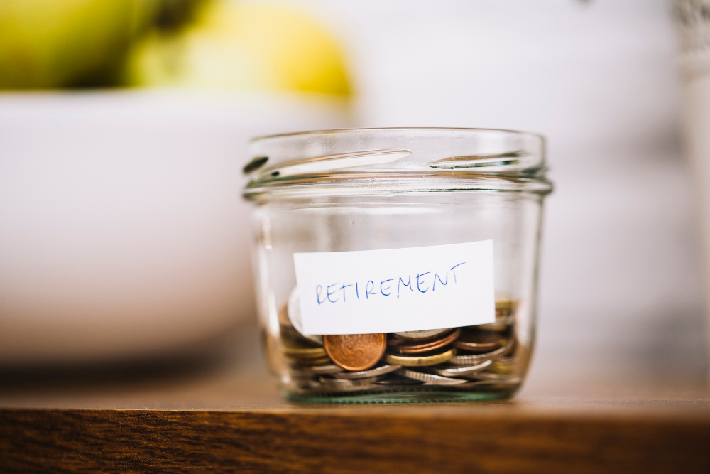 Coins In Glass Bowel With Retirement Label On Table