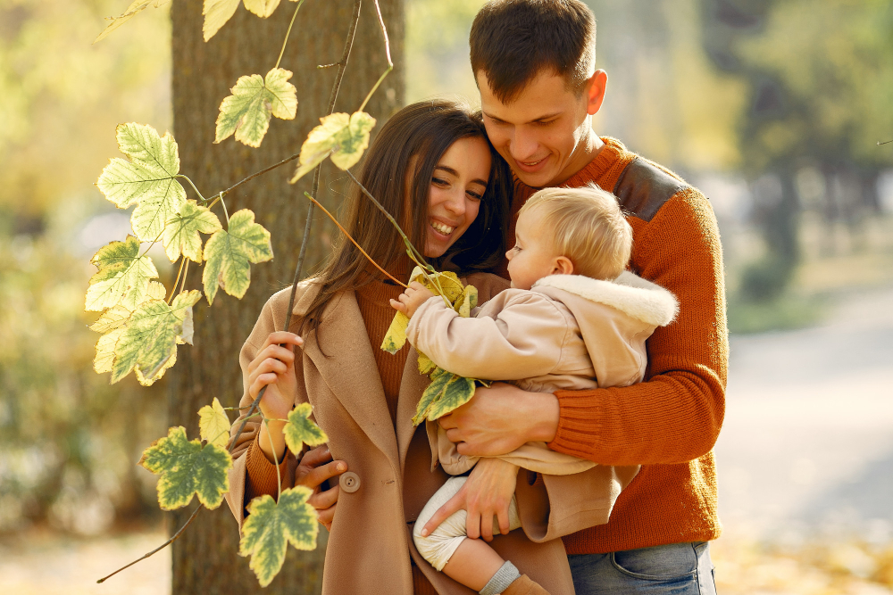 Family With Daughter During Autumn At The Park