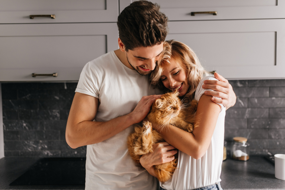 Man Looking At His Car And Embracing Wife Indoors In Kitchen