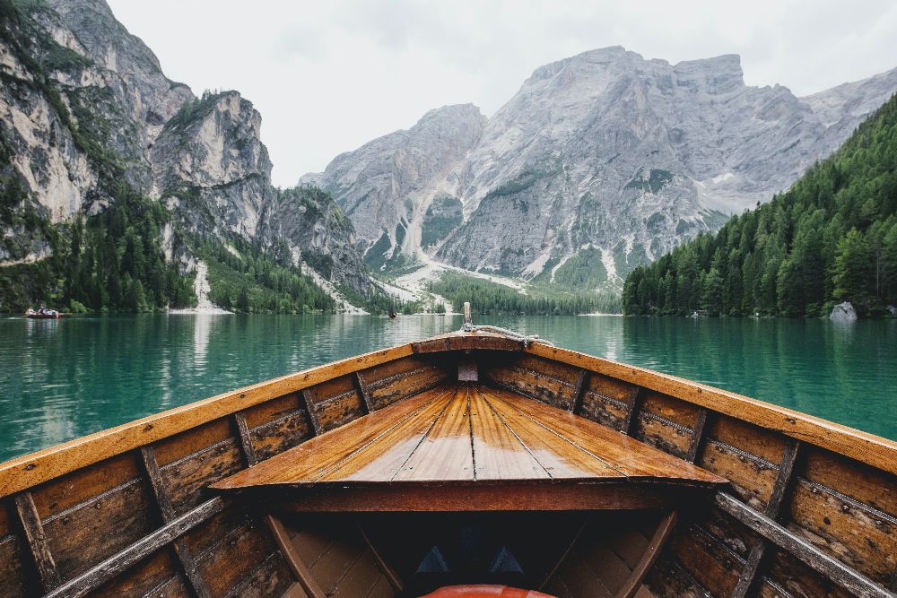 Canoe On A Lake Facing Mountains In The Distance