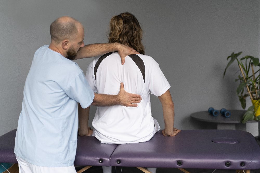 Chiropractor Working On Patient's Back