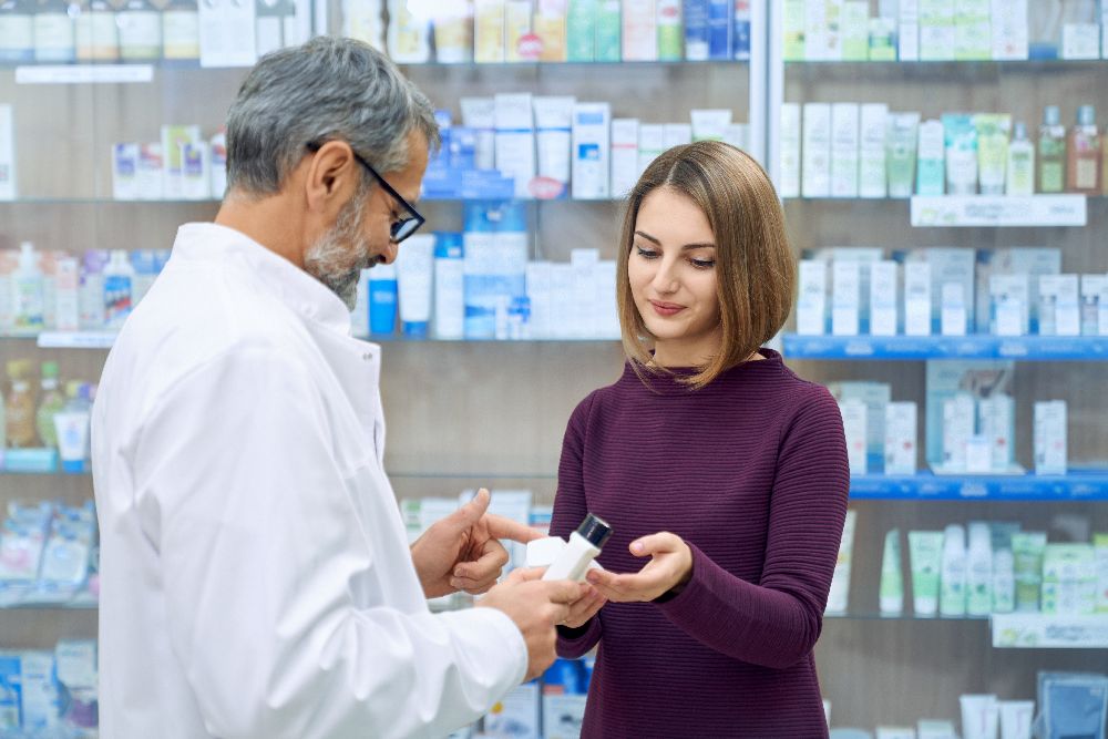 Pharmacist Helping Woman With Medicine Choice